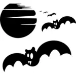 Vector clip art of bats at full moon
