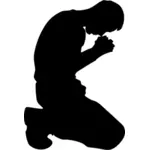 Человек на коленях в молитве силуэт