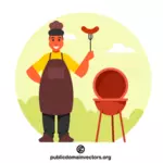 Šéfkuchař drží vidličku s klobásou