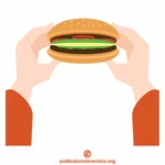 Hände halten einen Hamburger