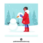 Chica haciendo un muñeco de nieve