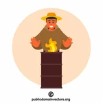 Homem de pé ao lado de um barril em chamas