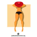 Femme au chapeau rouge prenant un bain de soleil