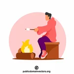 Mladý muž peče marshmallow