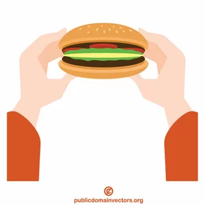 Mâinile țin un hamburger