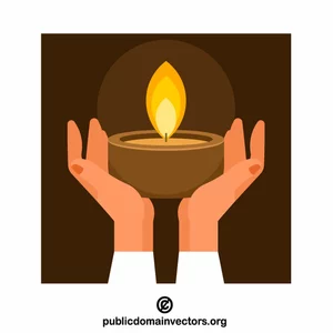 Hands lifting a candle