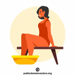 امرأة تجلس مع القدمين في الحوض