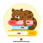 Kitten sleeping on a pile of books