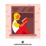 Nainen lukemassa kirjaa ikkunasta